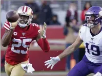  ?? TONY AVELAR - THE ASSOCIATED PRESS ?? San Francisco 49ers cornerback Richard Sherman (25) intercepts a pass in front of Minnesota Vikings wide receiver Adam Thielen (19) during the second half of an NFL divisional playoff football game, Saturday, Jan. 11, 2020, in Santa Clara, Calif.