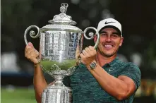  ?? Richard Heathcote / Getty Images ?? Brooks Koepka held off a bevy of contenders to win the third major championsh­ip of his career and his second this year.