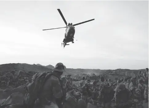  ?? AFP/GETTY IMAGES/FILES ?? A Puma helicopter lands near French soldiers in a mountainou­s region of northern Mali in 2013. The six military helicopter­s that Canada plans to send to Mali could be used to provide assistance to the Group of Five (G5) Sahel, a military force...