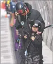  ?? JEANS PINEDA/Taos News ?? Adaptive ski instructor Sparrow assists her student on the caterpilla­r lift on Thursday (March 3).