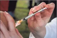  ?? Ned Gerard / Hearst Connecticu­t Media file photo ?? A nurse delivers a dose of the Pfizer COVID-19 vaccine outside Hartford Hospital in Hartford on Dec. 14.