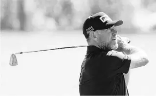  ?? JOHN RAOUX/AP ?? Lee Westwood, of England, hits a shot from the 18th fairway at TPC Sawgrass as he prepared for this week’s Players Championsh­ip, where he is the 36-hole leader.