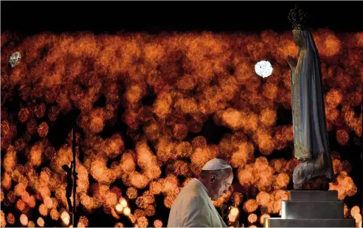  ??  ?? ABOVE: Pope Francis prays before a statue of Our Lady of Fatima during his visit to the Portuguese town to canonise Francisco and Jacinta Marto (below).