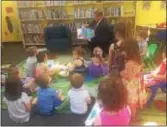  ?? KATHLEEN CAREY – DIGITAL FIRST MEDIA ?? County Councilman Dave White reads “Pete the Cat” along with some young charges as part of the kickoff of Library Quest 2017: Journey Across Delco, Tuesday at Haverford Township Free Library. the