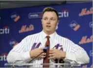  ?? SETH WENIG — THE ASSOCIATED PRESS ?? New York Mets’ Jay Bruce adjusts his jersey during a baseball news conference at Citi Field in New York, Wednesday. Bruce and the Mets have finalized a $39 million, three-year deal to bring his big bat back to Queens.