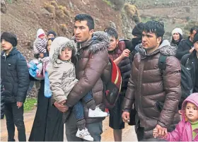  ?? Picture: AP. ?? Migrants walk to the Greek village of Skala Sikaminias.