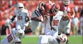  ?? / AP - Mike Stewart ?? Georgia running back D’Andre Swift leaps over Austin Peay defenders Kordell Jackson (13) and Elijah Shepard during the first half of Saturday’s game.