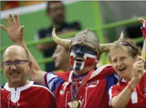  ?? MATTHIAS SCHRADER — THE ASSOCIATED PRESS ?? In this Thursday file photo Norwegian fans wait for the beginning of the women’s semifinal handball match between Norway and Russia at the 2016 Summer Olympics in Rio de Janeiro, Brazil. A global happiness report has made the Norwegian foreign...