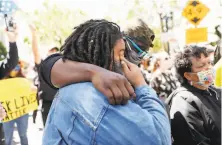  ??  ?? Taylor and Arian Bryant get emotional at the rally against police brutality protest outside the Oakland police headquarte­rs.