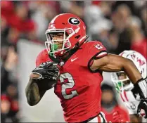  ?? HYOSUB SHIN/HYOSUB.SHIN@AJC.COM ?? Georgia running back Kendall Milton was one of eight college football players who entered into an NIL deal with the U.S. Marines. The athletes share videos to social media, discussing how their values align with the Marines.