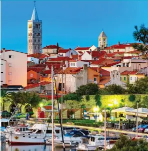  ??  ?? ELEGANCE: The marina at Rab, overlooked by its famous bell towers