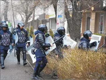  ?? Vladimir Tretyakov Associated Press ?? SECURITY FORCES try to cut off protesters this month in Almaty, Kazakhstan. A sudden increase in the price of vehicle fuel triggered the protests, which then spread to more than a dozen cities and towns.