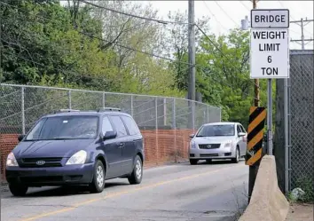  ?? John Heller/Post-Gazette ?? The 108-year-old Kenmawr bridge, which connects Rankin and Swissvale, had its weight limit increased from 6 tons to 12 tons after repairs were made to increase its capacity, but buses and large trucks cannot use it. The bridge will be replaced next year.
