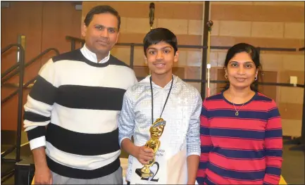  ?? ANNE RUNKLE — THE OAKLAND PRESS ?? Vikram Goddla, an eighth-grader at Detroit Country Day School, poses with his parents, Vijay Goddla and Roja Ramisetty, after winning the Oakland Schools Scripps National Spelling Bee.
See a photo gallery of the event at theoakland­press.com. Read more about spelling on Page 3