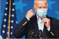  ?? Carolyn Kaster / Associated Press ?? President- elect Joe Biden removes his face mask to speak at The Queen theater on Thursday in Wilmington, Del.