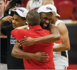  ?? KASSI JACKSON — HARTFORD COURANT VIA AP ?? Hartford’s Austin Williams and head coach John Gallagher of Cardinal O’Hara embrace after beating UMass-Lowell in the championsh­ip of the America East tournament on Saturday in Hartford, Conn.