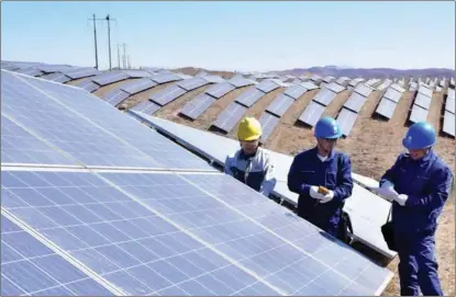  ?? JIA MINJIE / FOR CHINA DAILY ?? Workers check grid-connected facilities at a photovolta­ic power plant in Shijiazhua­ng, Hebei province.