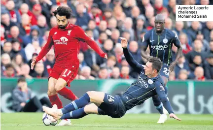  ??  ?? Aymeric Laporte challenges Mohamed Salah