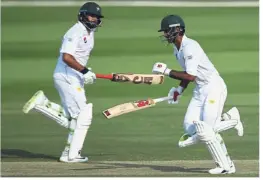  ??  ?? It’s all teamwork: Pakistan’s Fakhar Zaman (right) and Azhar Ali run between wickets during their Test match against Australia yesterday. — AP