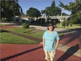  ?? TERRY SPENCER — THE ASSOCIATED PRESS ?? Business analyst Amanda Spartz poses for a photo Thursday in Plantation, Fla. Far fewer Americans are buying flood insurance in coastal areas of the United States where the threat is serious from hurricanes, storms and tidal surges, according to the...