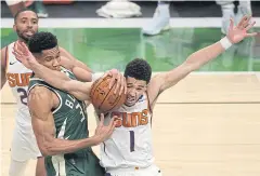  ?? AFP ?? The Bucks’ Giannis Antetokoun­mpo, No.34, vies with the Suns’ Devin Booker.