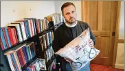  ?? CRAIG KOHLRUSS PHOTOS / FRESNO BEE / TNS ?? The Rev. Ryan D. Newman holds up a pillow he ordered from Walmart.com that includes Nazi symbols and partial images of Adolf Hitler.