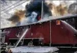  ?? PHOTO FROM EARL TOWNSHIP VOLUNTEER FIRE COMPANY ?? Firefighte­rs battle a large barn fire early Friday morning in Washington Township. No injuries were reported.