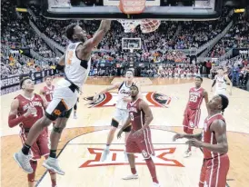  ?? (AP Photo/Charlie Riedel) ?? Oklahoma State’s Cameron McGriff dunks during the second half of an NCAA college basketball game against Oklahoma in the Big 12 men’s tournament Wednesday, March 7, 2018, in Kansas City, Mo.