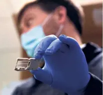  ??  ?? A FLOW CELL used for sequencing the coronaviru­s at a lab in Seattle, April 15. Analysing a virus’ genetic code lets researcher­s track its mutations.