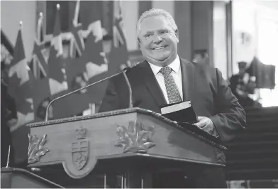  ?? MARK BLINCH / THE CANADIAN PRESS ?? Doug Ford is sworn in as premier of Ontario during a ceremony at Queen’s Park in Toronto on Friday.