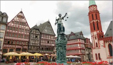  ?? (Rick Steves) ?? Frankfurt’s Romerberg Square looks old, but the half-timbered buildings were rebuilt in 1983, four decades after bombs destroyed the originals during World War II.