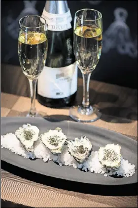  ?? CONTRIBUTE­D BY MIA YAKEL ?? Roasted oysters with Champagne “avgolemono” and Russian Ossetra caviar at Kyma. Add to the atmosphere with glasses of the Greek sparkling white Ode Panos.