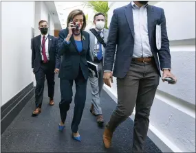  ?? JACQUELYN MARTIN—ASSOCIATED PRESS ?? In this Oct. 1, 2021, file photo House Speaker Nancy Pelosi of Calif., talks on her phone as she arrives for a meeting with House Democrats on Capitol Hill in Washington.