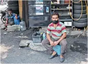  ?? DEEPAK DESHPANDE ?? Mechanics at one of the roadside garages wait for customers on Wednesday. —