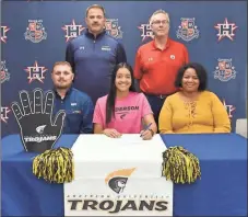  ??  ?? Heritage senior Ariana Camp is joined by Nick and Marissa Camp as she signed papers to attend and play basketball for Anderson (S.C.) University last week. Among those on hand for the ceremony included Heritage assistant basketball coach Mark Gamble and Heritage head coach Eddie Bryant.