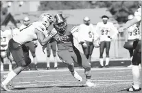  ?? GARY MIDDENDORF/DAILY SOUTHTOWN ?? St. Xavier’s Tim Baity looks to block a punt on Saturday. His block in the fourth quarter was returned by a teammate for a touchdown.