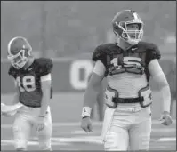  ?? NWA Democrat-Gazette/J.T. Wampler ?? TAKING CHARGE: Arkansas sophomore quarterbac­k Cole Kelly (15) yells during a rainy-day practice at the Razorbacks’ outdoor practice facility Tuesday. Head coach Chad Morris said Tuesday Kelly and fourth-year junior Ty Storey are still neck-and-neck in the battle for the starting quarterbac­k position.