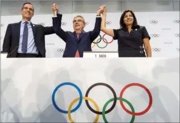  ?? JEAN-CHRISTOPHE BOTT — KEYSTONE VIA AP, FILE ?? Int his file photo, from left, Mayor of Los Angeles Eric Garcetti, Internatio­nal Olympic Committee (IOC) President Thomas Bach, and Mayor of Paris Anne Hidalgo gesture during a press conference after the IOC Extraordin­ary Session at the SwissTech...