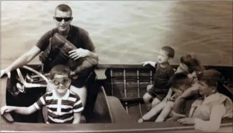  ?? NORMAN FAMILY VIA AP ?? This July 1965 photo provided by the Norman family shows Dr. Richard Norman in his boat on the St. Lawrence River with sons David and Peter, nephew John and cousins. At 84, the former athlete-turned-dentist and father of four had been struggling with...