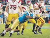  ?? Tom Mendoza Associated Press ?? ERIC McNEAL of UCLA intercepts a pass against USC in 2006. The heavily favored Trojans lost 13- 9.