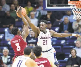  ?? Stephen Dunn / AP ?? UConn’s Mamadou Diarra (21) blocks a shot by Temple's Shizz Alston Jr. (3) in the first half of a game on Wednesday, Feb. 28, 2018, in Storrs.