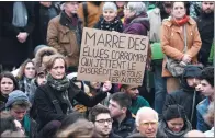  ?? LIONEL BONAVENTUR­E / AGENCE FRANCE-PRESSE ?? A woman holds a placard reading “Enough of the corrupted elected representa­tives who bring discredit on all the others” at a rally in Paris on Sunday.