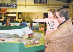  ?? Lara Green-Kazlauskas / For Hearst Connecticu­t Media / ?? Rose Bellagamba and her grandfathe­r, Jorge Varas of Derby, enjoy the annual train show hosted by the Torrington Area Model Railroader­s, Sunday at the Torrington Armory.