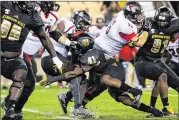  ?? CONTRIBUTE­D BY CORY HANCOCK ?? Kennesaw State’s Anthony Gore Jr. (41) tackles GardnerWeb­b QB Tyrell Maxwell as the Owls consistent­ly came up with big plays on defense.