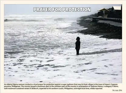  ?? PICTURE: EPA ?? An elderly Filipina woman conducts a ritual prayer for protection against a super typhoon that may hit their village in the town of Aparri, Cagayan province, Philippine­s. The country issued a maximum alert in the northern part of the country in...