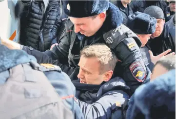  ?? — Reuters photo ?? Police officers detain Navalny during a rally in Moscow.