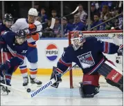  ?? SETH WENIG — THE ASSOCIATED PRESS ?? New York Rangers goaltender Igor Shesterkin, right, defends the goal during the second period of an NHL hockey game against the New York Islanders, Sunday, March 17, 2024, in New York.