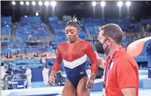  ?? Wally Skalij/Los Angeles Times/TNS ?? U.S. gymnast Simone Biles is consoled after competing on the vault and withdrawin­g from competitio­n due to an injury in the women’s team final on Tuesday in Tokyo, Japan.