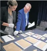  ?? RICARDO RAMIREZ BUXEDA/STAFF PHOTOGRAPH­ER ?? The Historic Preservati­on Office’s Heather Bonds, left, and Richard Forbes, study time capsule items.