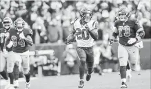  ?? TONI L. SANDYS THE WASHINGTON POST ?? Texans strong safety Justin Reid (20) runs back an intercepti­on for a touchdown during the second quarter Sunday against the Redskins.